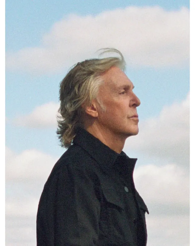 Profile portrait against sky, photographic, minimal, cool