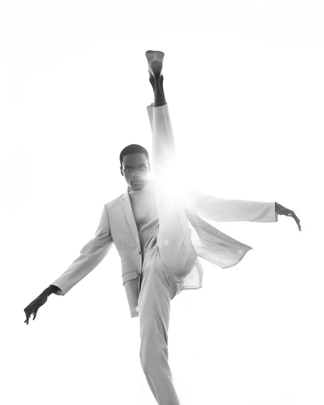 High-kick fashion editorial in white suit, editorial, monochrome, light