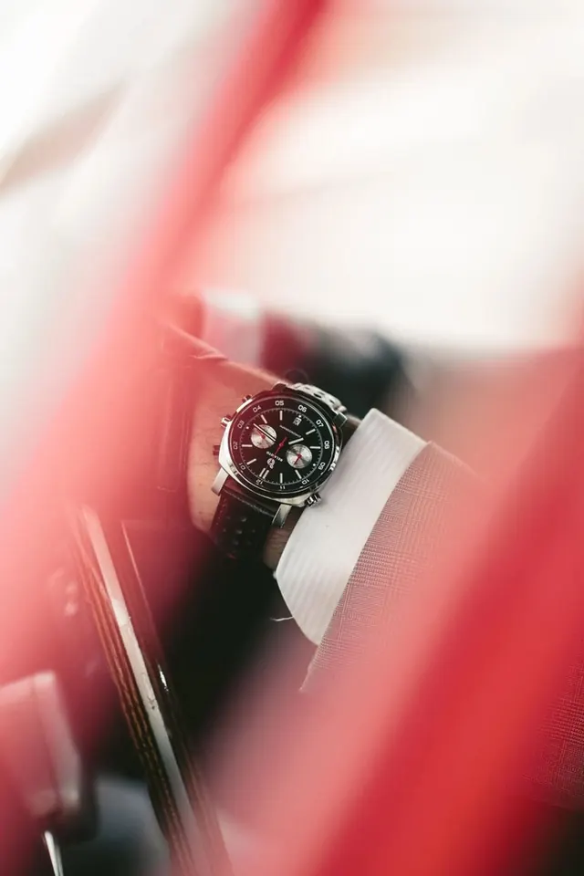 Belmoto chronograph through red bokeh frame, luxury, photographic, warm