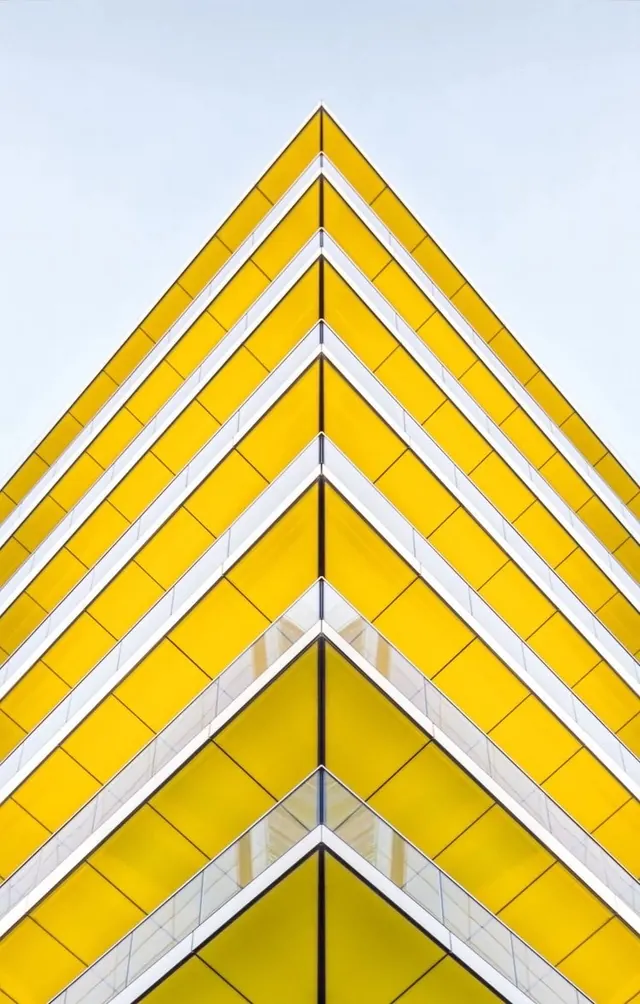 Yellow chevron apartment facade lookup, geometric, photographic, vibrant