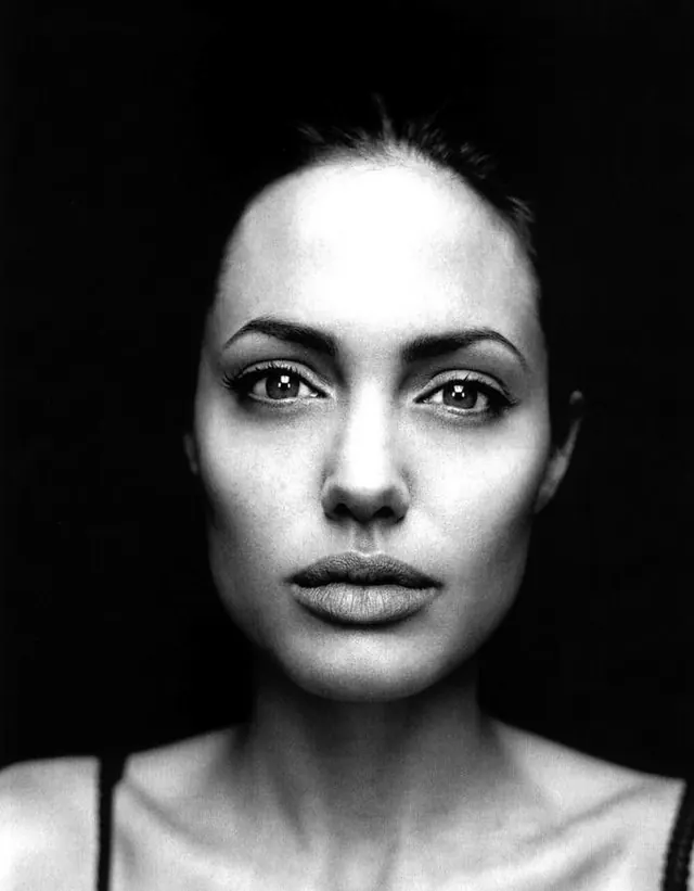 High-contrast monochrome portrait close-up, editorial, photographic, monochrome