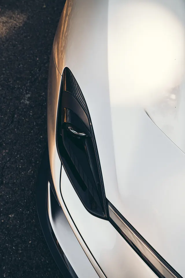Close-Up of Sleek White Car Headlight, minimal, technical, monochrome