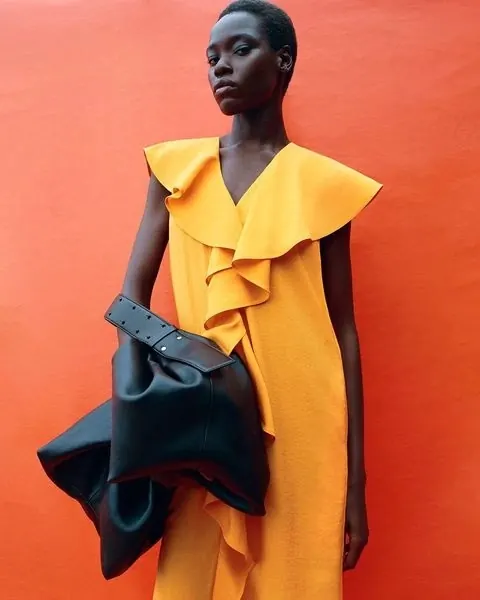 Model in Yellow Dress against Orange Background