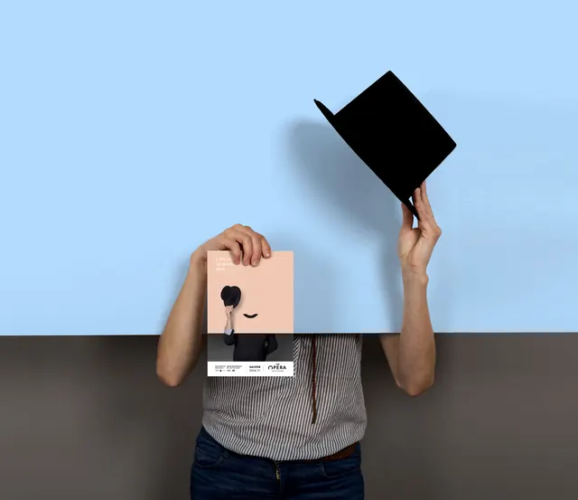 Person holding a white card with a black graphic