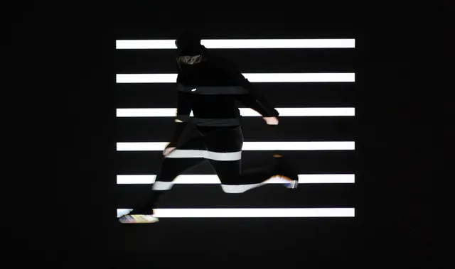 Runner crossing light bars, photographic, minimal, monochrome