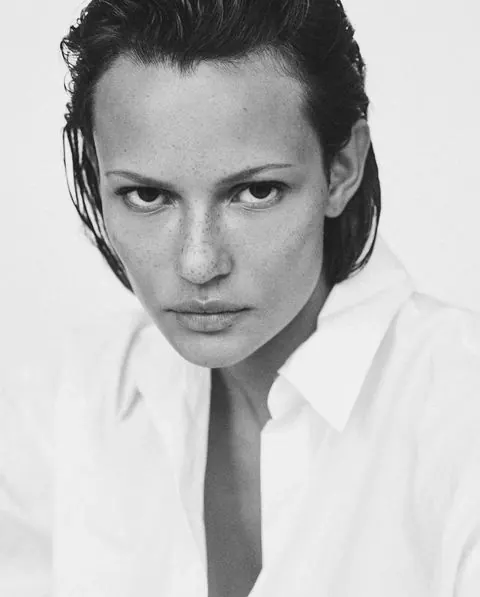 Freckled portrait in open white shirt, photographic, editorial, monochrome