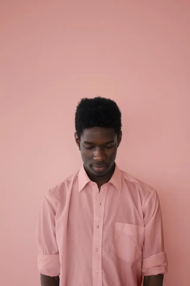 Pink monochrome portrait on rose wall, photographic, minimal, pastel