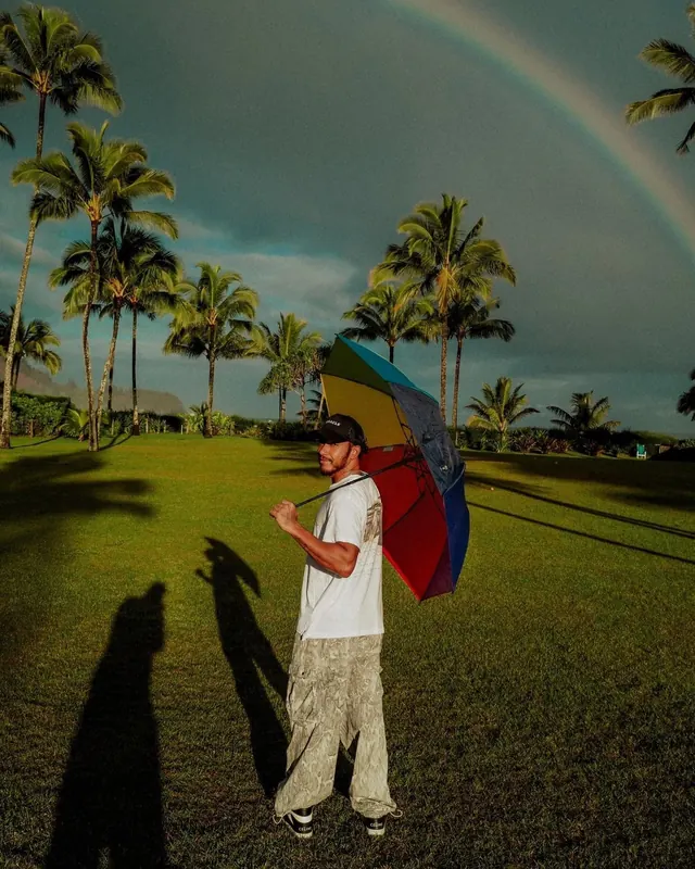 Rainbow umbrella in tropical field, photographic, vibrant, vibrant