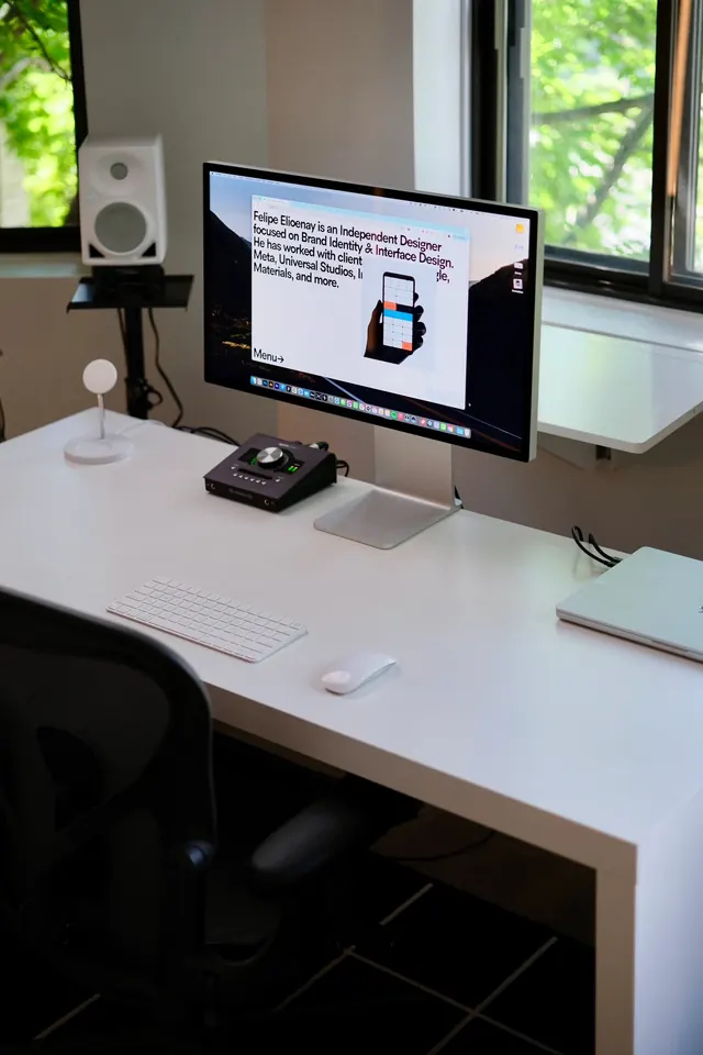Minimal designer desk with Studio Display, minimal, corporate-clean, light