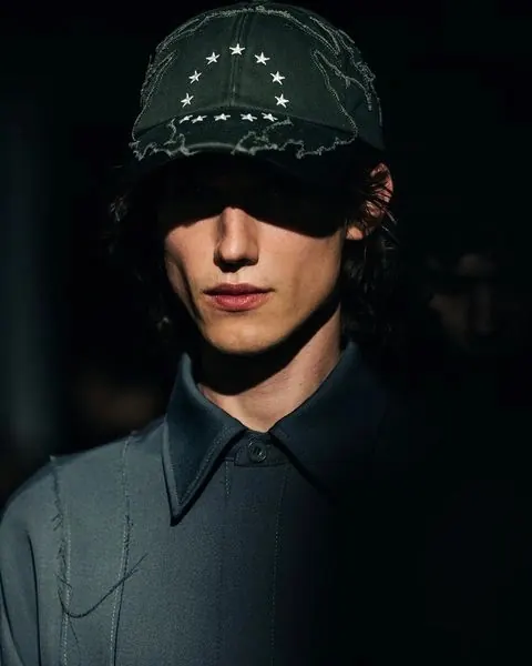 Moody portrait in distressed star cap, photographic, minimal, dark