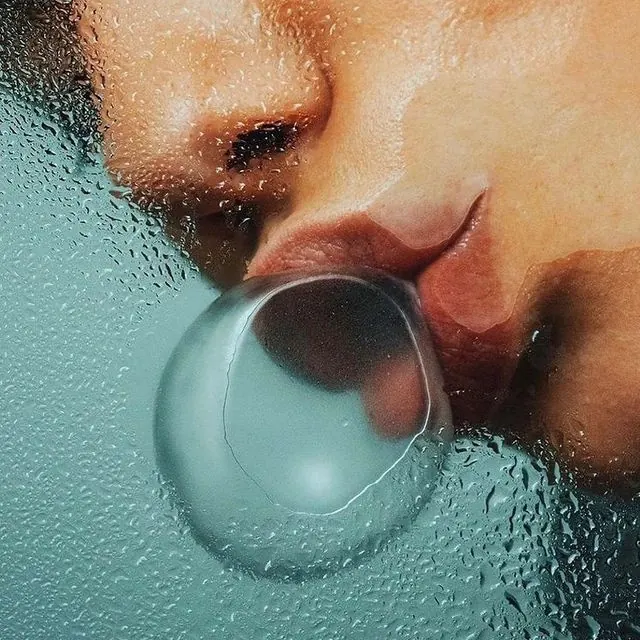 Face pressed to glass with bubble and droplets, photographic, abstract, cool