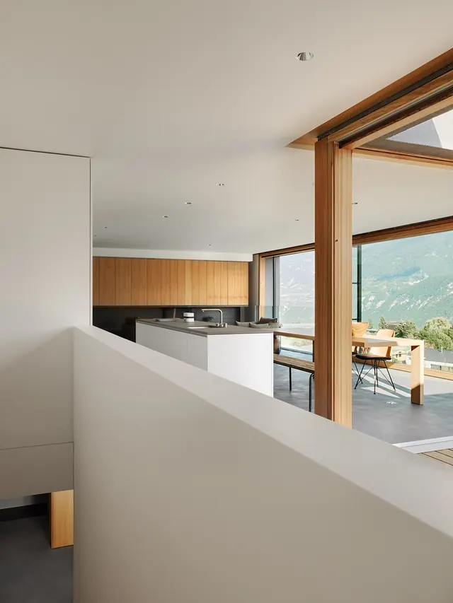 Alpine kitchen with wood panels and mountain view, minimal, organic, light