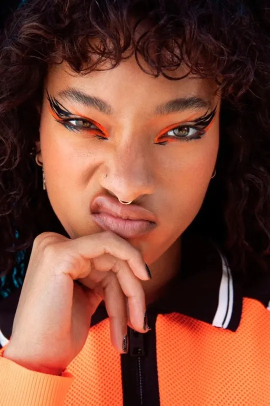 Neon orange graphic liner beauty close-up, photographic, maximalist, vibrant