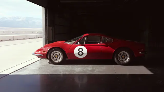 Red vintage sports car in hangar, photographic, minimal, dark