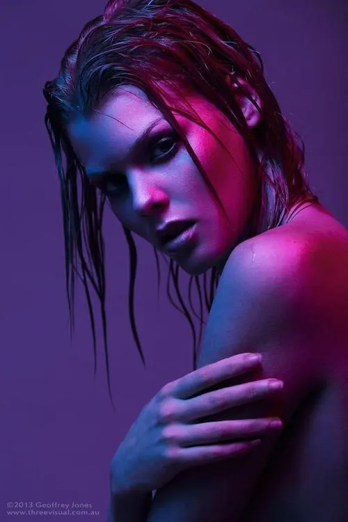 Portrait of a woman with red hair and blue lighting