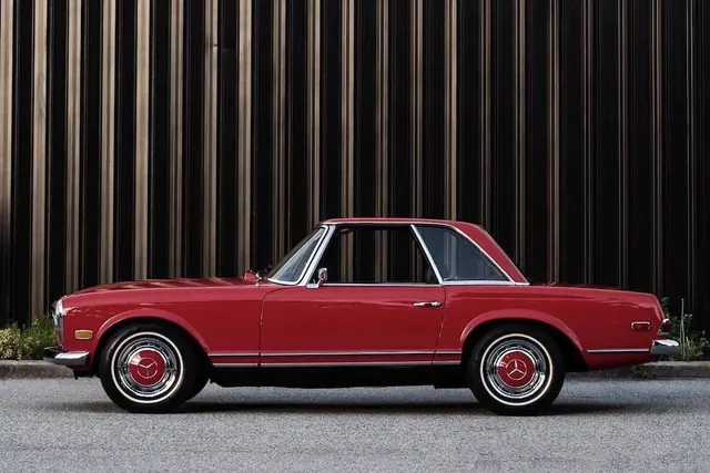 Red Classic Car against Vertical Slats