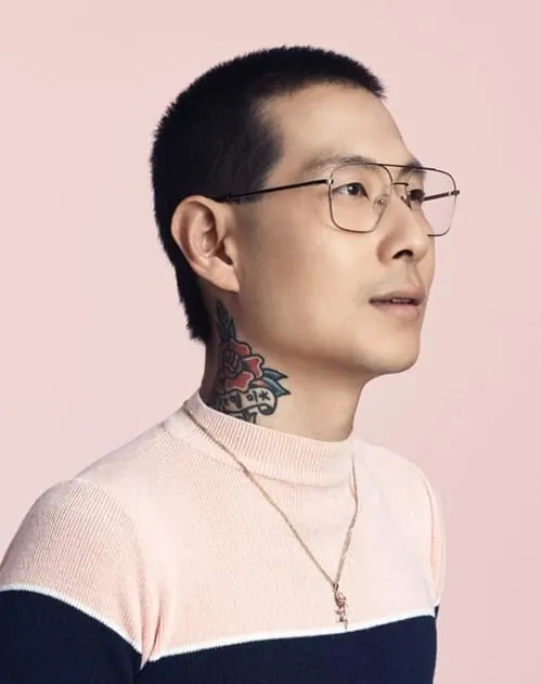 Portrait of man with neck tattoo and glasses, minimal, photographic, light