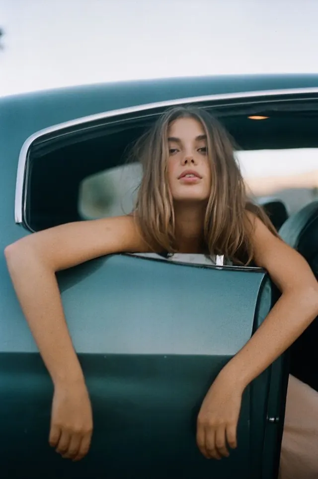 Portrait of a woman in a vintage car