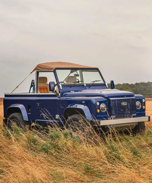 Vintage Land Rover in Field