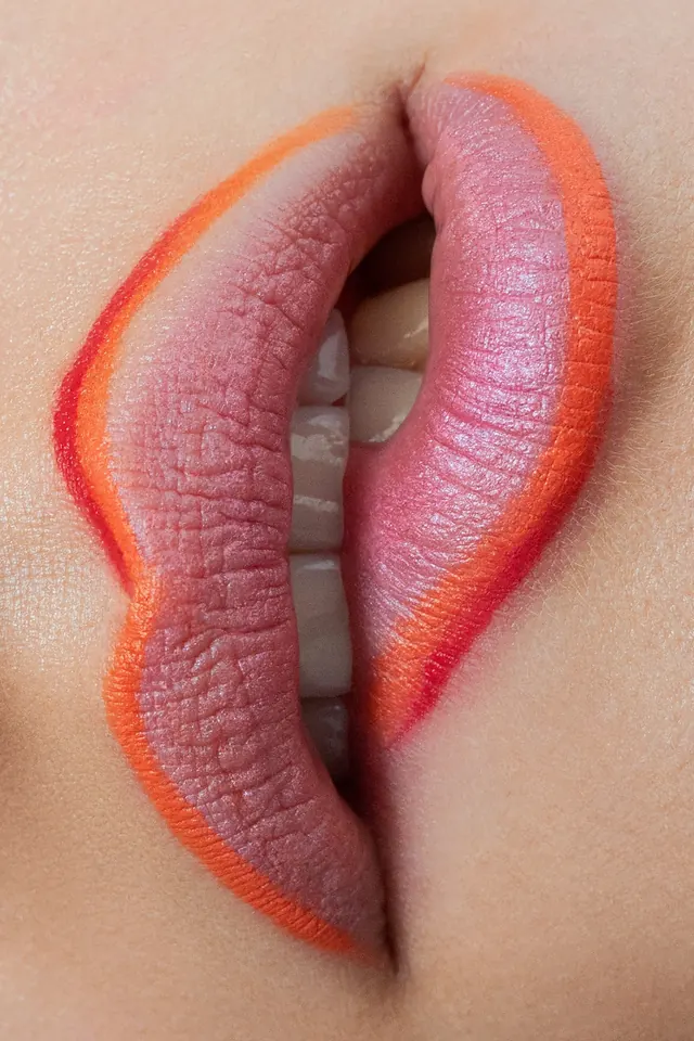 Orange-lined lip close-up, photographic, warm