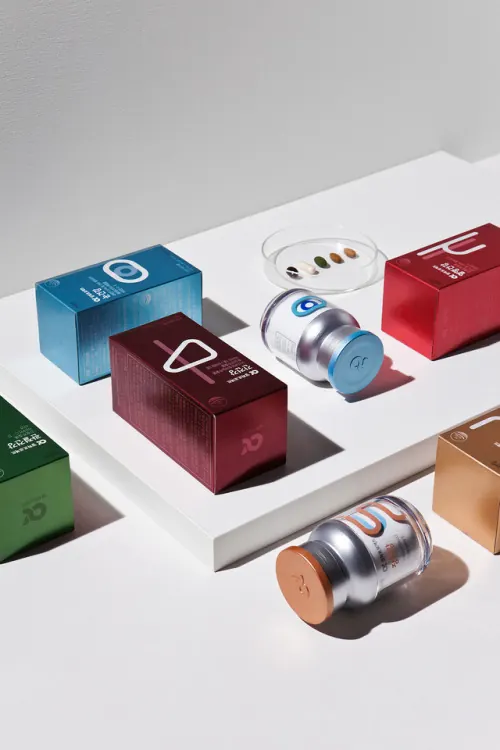 Colorful wellness product packaging on white, minimal, corporate-clean, vibrant