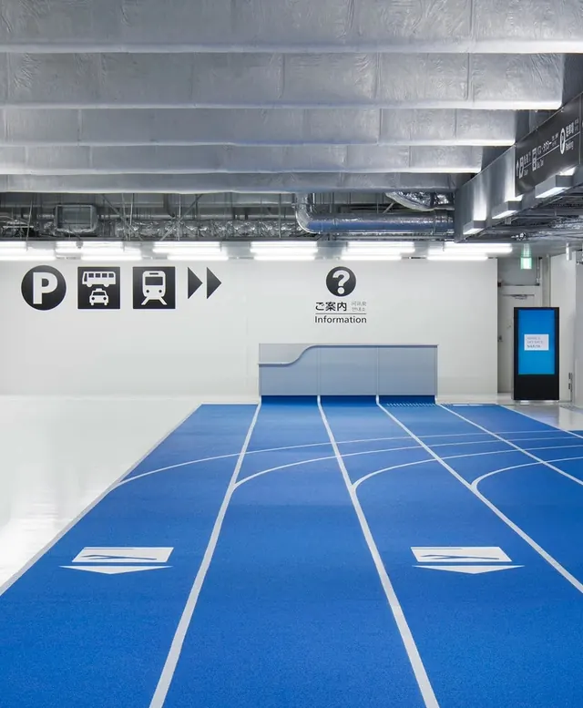 Blue floored modern transit station interior, minimal, technical, vibrant