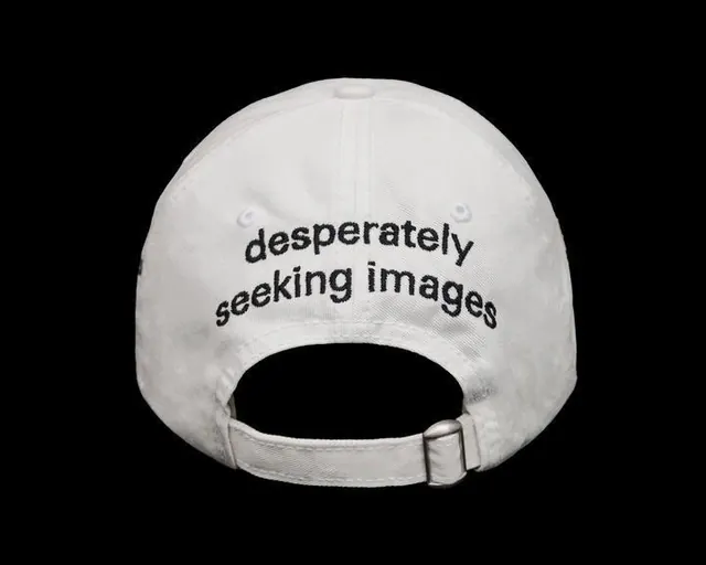 White cap with desperately seeking images text, minimal, monochrome, light