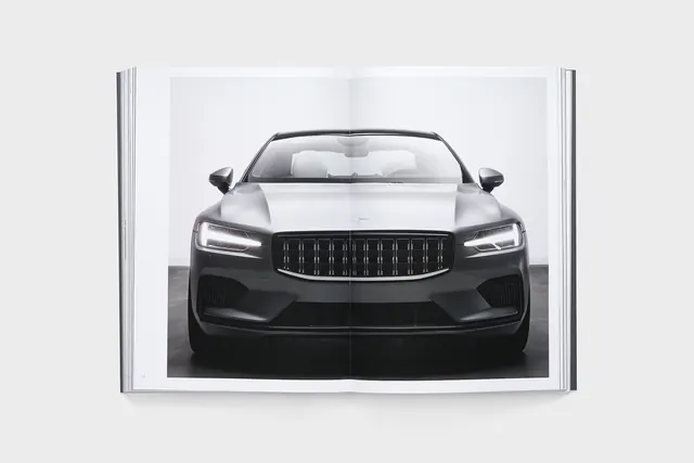 Polestar car front in open magazine spread, minimal, corporate-clean, monochrome