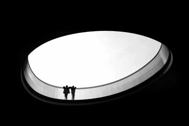 Architectural amphitheater silhouette with figures, photographic, minimalist, monochrome