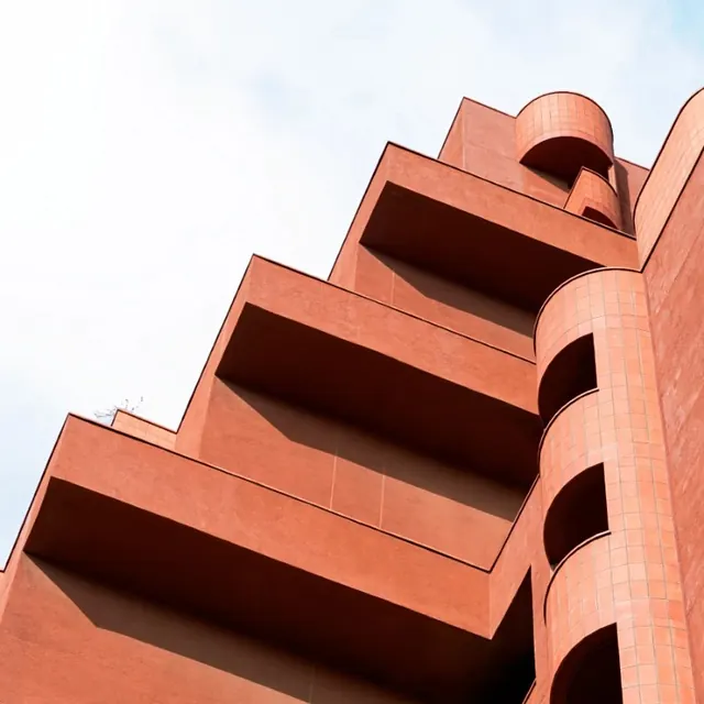 Modernist terracotta building with stepped architecture, photographic, architectural, warm