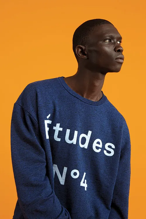 Études apparel portrait with warm color backdrop, photographic, playful, vibrant