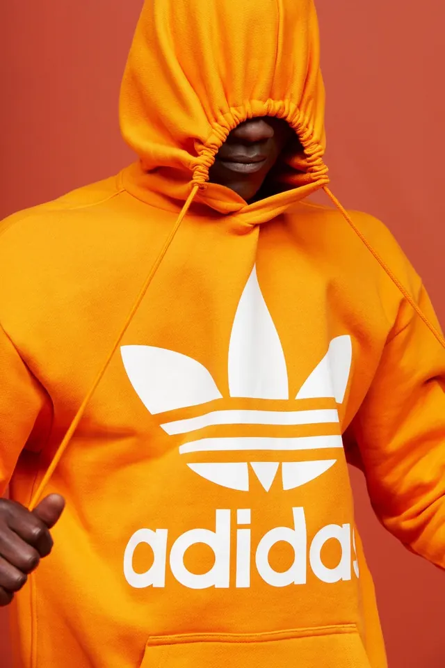 Adidas Originals orange hoodie, photographic, playful, warm