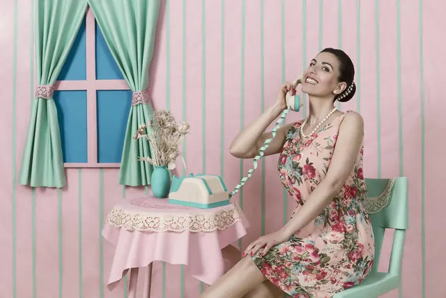 Vintage-inspired set design with woman, phone, and florals, photographic, editorial, pastel