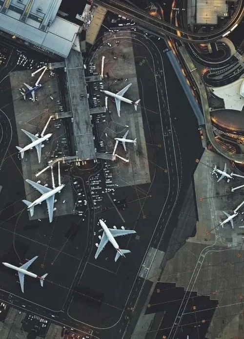 Overhead aerial view of airport tarmac, photographic, technical, dark