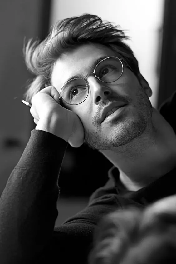 Black and white portrait with round glasses, monochrome, photographic, dark