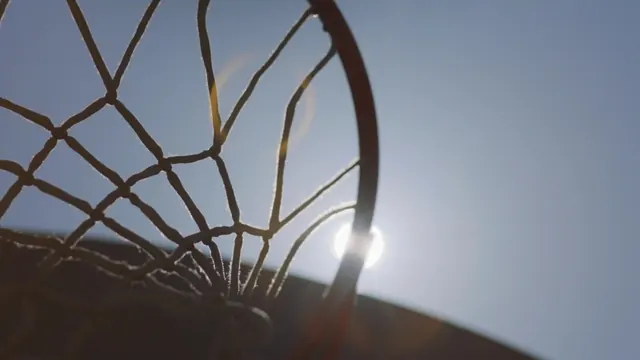 Overhead shot of basketball hoop against clear sky, photographic, minimal, light