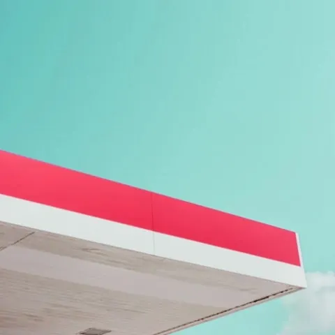 Minimalist architectural detail—pink stripe against turquoise sky, minimal, corporate-clean, light