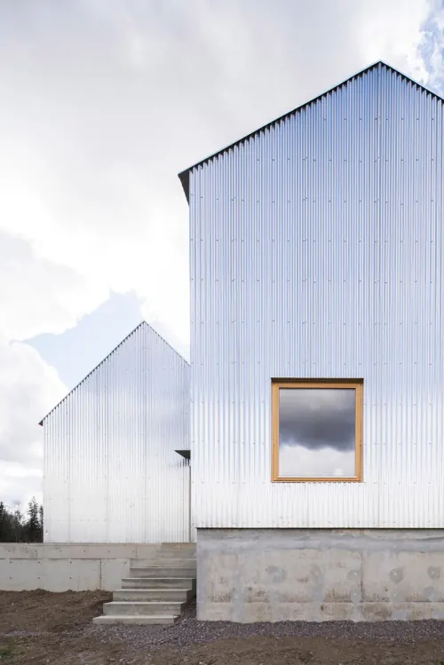 Modern residential architecture with corrugated metal facade, minimal, brutalist, light