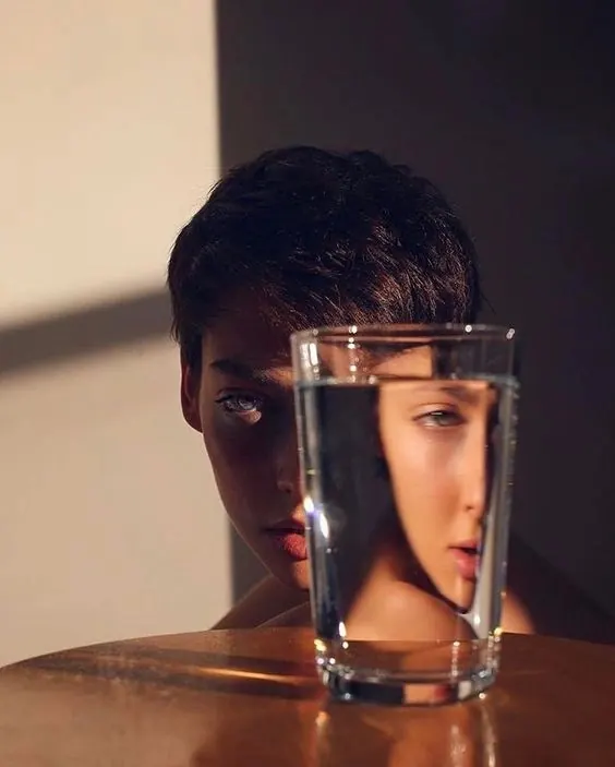 Portrait with water glass refraction effect, photographic, artistic, warm
