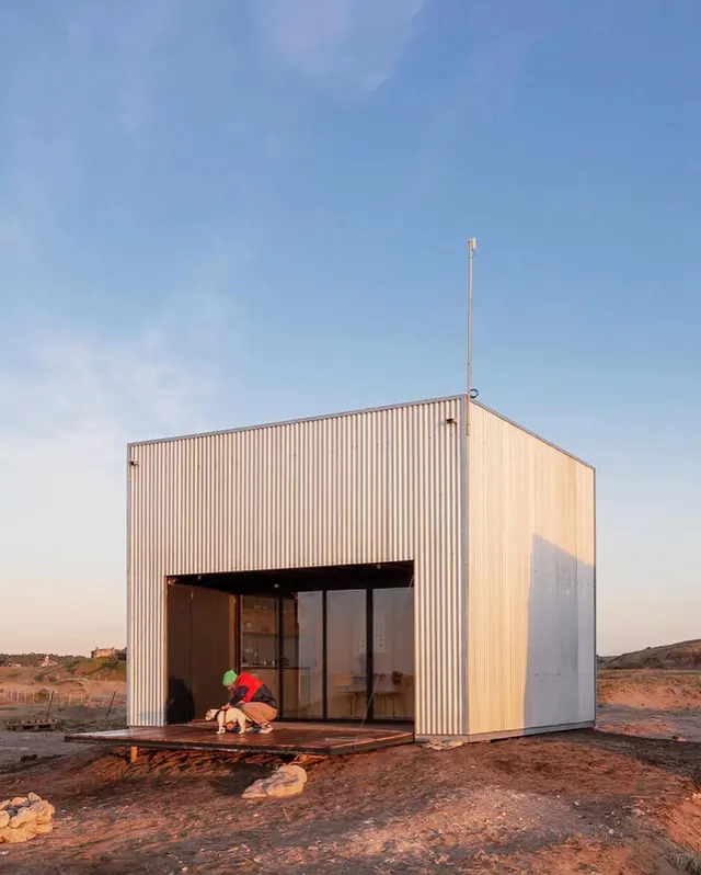 Minimalist metal container cabin on desert landscape, minimalist, photographic, cool
