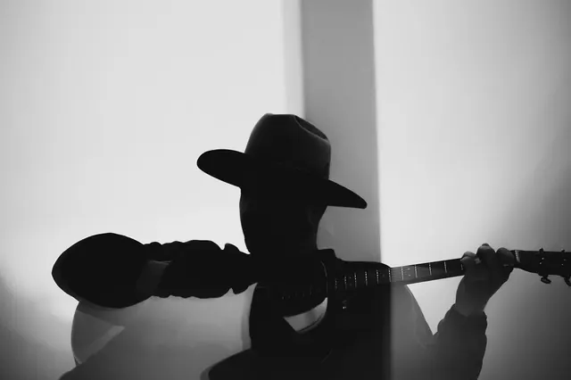 Silhouette portrait of musician with cowboy hat, photographic, monochrome, monochrome
