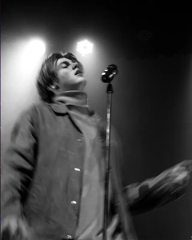 Black and white concert performance with stage lights, photographic, dark-mode, dark