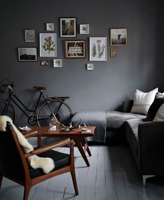 Gallery wall arrangement with botanical and landscape art, editorial, minimal, dark