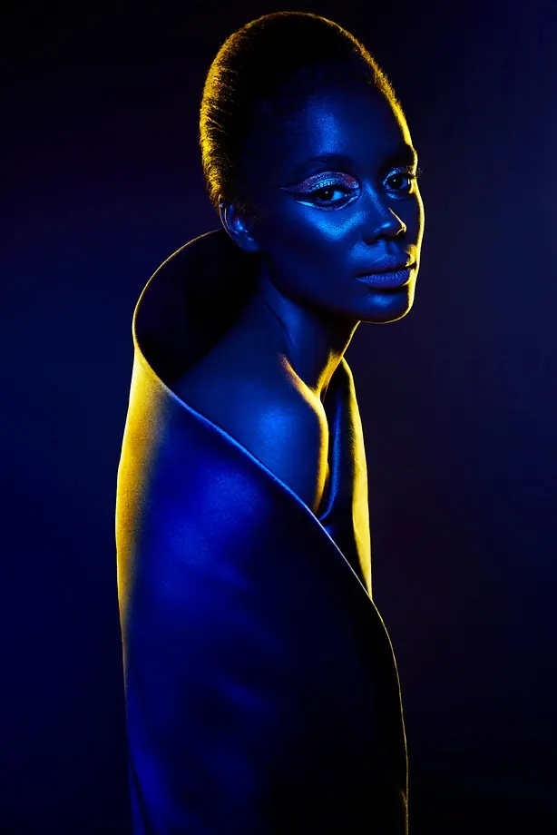 Portrait with dramatic blue and gold lighting, photographic, technical, dark