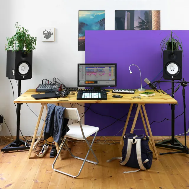 Music production studio setup with purple accent wall, minimal, photographic, warm