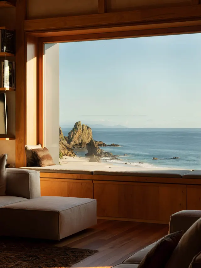 Coastal interior with ocean view through large window, minimal, organic, warm