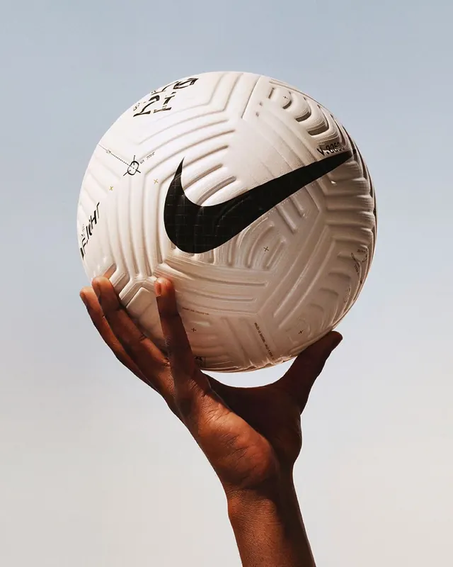 Nike basketball held aloft with sculpted detail closeup, photographic, minimal, light