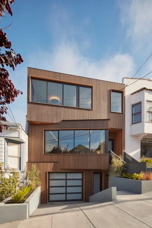 Modern residential architecture with vertical ribbed metal facade, technical, minimal, warm