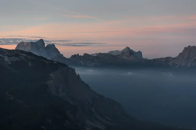 Alpine mountain landscape at dawn with mist, photographic, editorial, cool