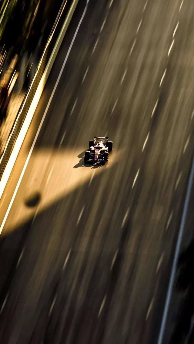 Formula 1 racing car with motion blur, photographic, dark